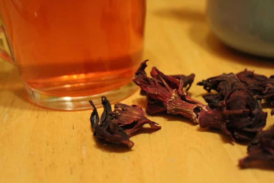 hibiscus tea leaves and a mug of hibiscus tea